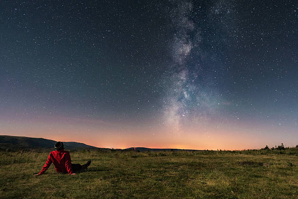 A young man lying on the grass and watching the Milky Way. Taken in A Veiga, Orense.

